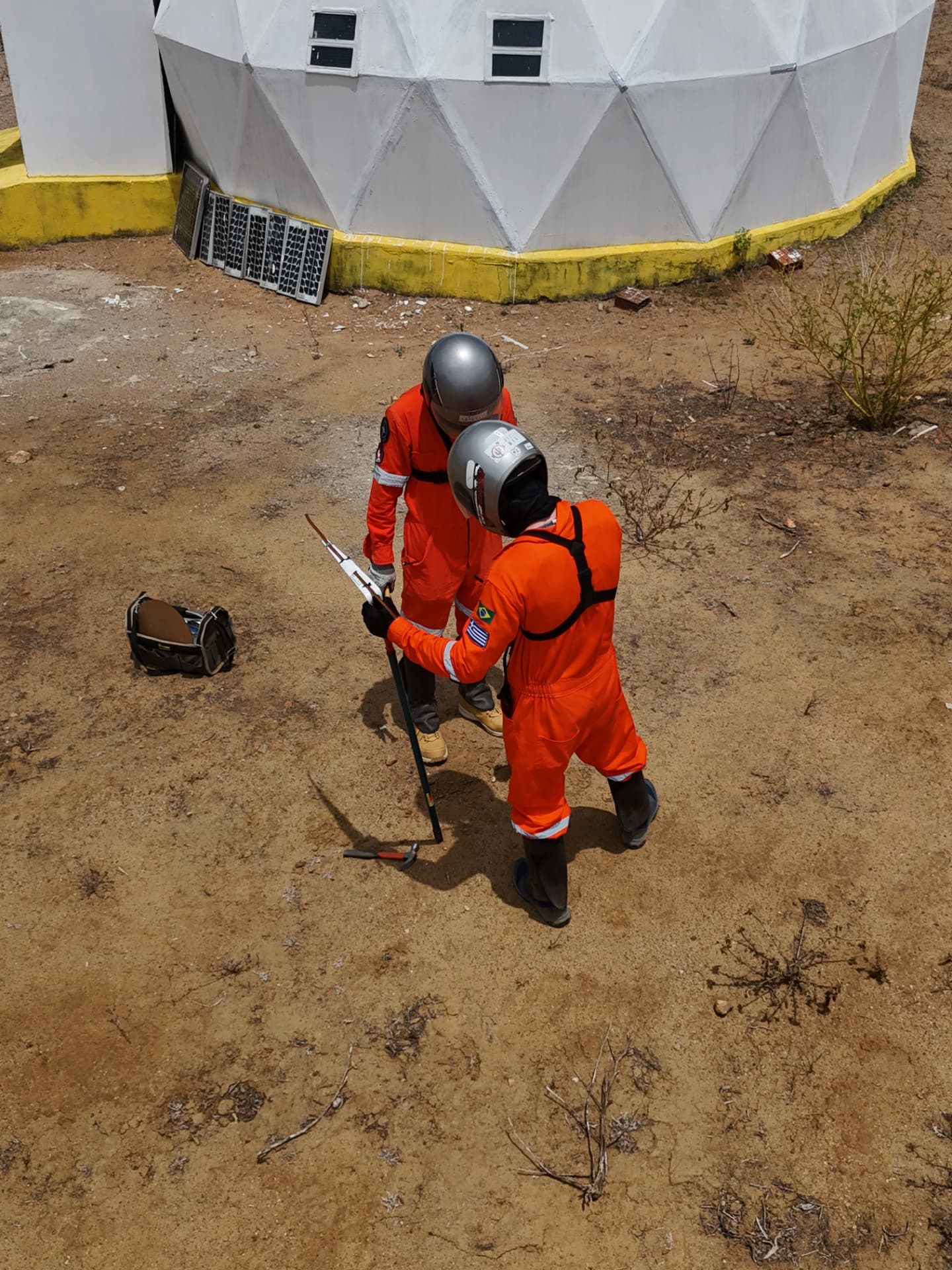 Analog astronauts working with tools outside the habitat dome at HABITAT MARTE